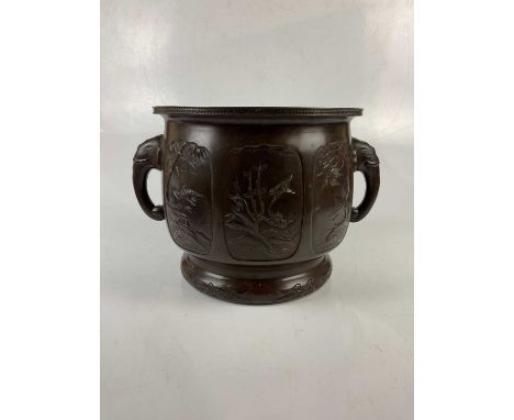 A large Japanese Meiji period bronze twin handled planter, cast decorated with exotic birds and landscape scenes, with elepha