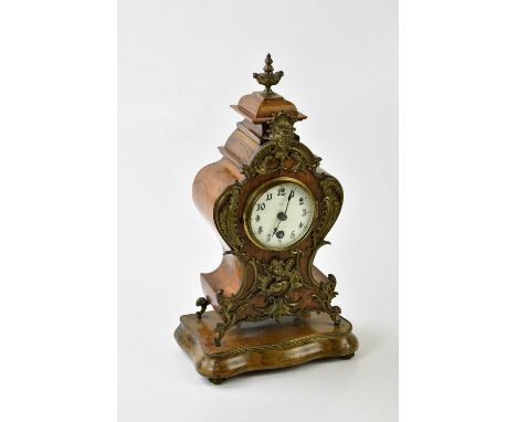 LENZKIRCH; an early 20th century German mantel clock with urn finial and gilt applied decoration of mask heads and scrolls, t