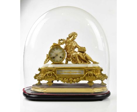 A French gilt mantel clock, with a figure of a female holding a book, the dial set with Roman numerals, on black wooden plint