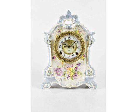 An early 20th century ceramic mantel clock with transferred printed floral decoration, with Ansonia Clock Company movement, t