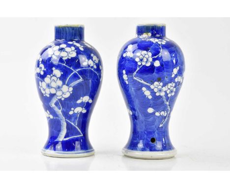 A pair of of late 19th/early 20th century Chinese blue and white vases with prunus decoration, bearing four character Kangxi 