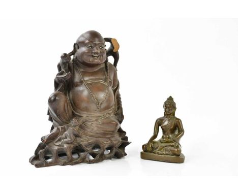 A Tibetan bronze model of seated Buddha, height 9cm, and a Chinese carved rootwood figure of a god (2)