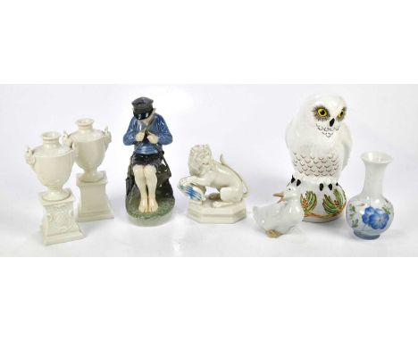 A mixed collection of ceramic figures to include a Crown Staffordshire snowy owl, a Royal Copenhagen seated figure of boy and