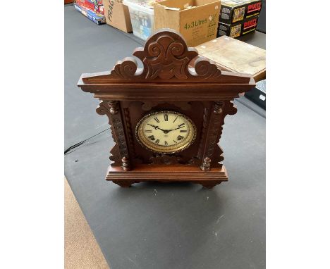 ANSONIA CLOCK COMPANY, NEW YORK; a stained pine gingerbread type mantel clock, the circular dial set with Roman numerals, hei