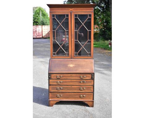 An Edwardian inlaid mahogany bureau bookcase, the moulded cornice above a pair of astragal glazed doors and adjustable shelve