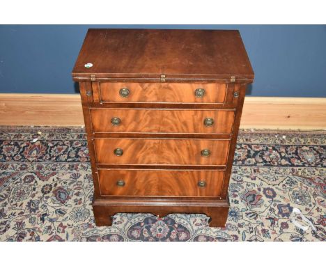 REPROX; a reproduction mahogany chest of drawers with folding top above four drawers on bracket feet, width 59cm, depth 32cm,