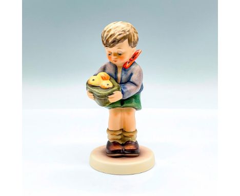 Hand painted exclusive edition figure of a young boy holding a bag of apples. Goebel backstamp. This item has its original bo