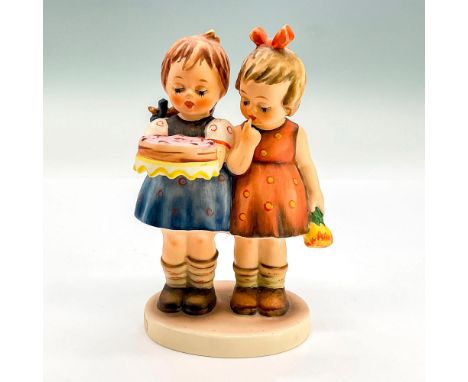 Hand painted figure of two young girls, one is holding a cake with pink frosting. The other girl is holding a bunch of flower