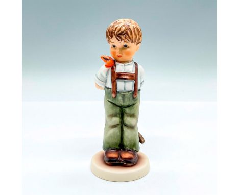 Hand painted exclusive edition figure of a young boy hiding a bow behind his back. Goebel backstamp. This item has its origin