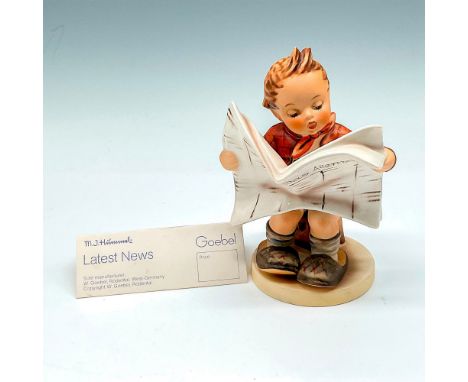 Little figural with matte finish, holding a newspaper, German version, reading in father's slippers. Goebel backstamp. M.I. H