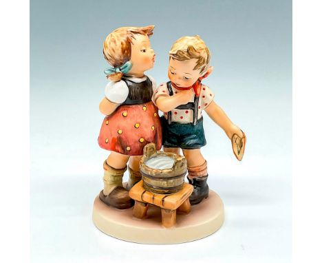 Hand painted figural of girl and boy over a bucket of water. Goebel backstamp. M.I. Hummel impressed mark. This item has its 