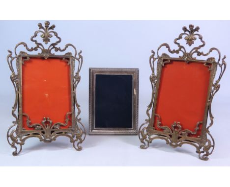 Pair of Art Nouveau easel picture frames with pierced brass scrolling borders, H26cm and a silver frame, by A.M.W, Sheffield 