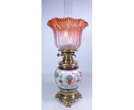 19th century Sampson of Paris style oil lamp, the porcelain body hand painted with and armorial amongst floral sprays, with f