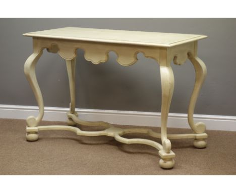 Distressed painted and waxed console table, moulded rectangular top above shaped skirt, scroll cabriole supports connected by