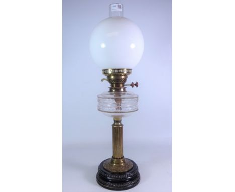 Victorian brass oil lamp, with black glazed base, cut glass reservoir and opaque glass shade and funnel, H63cm     Condition 