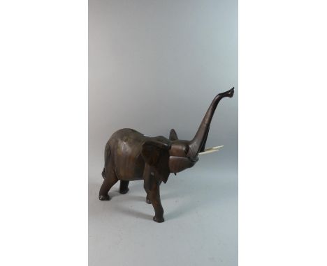 A Carved Wooden Study of an African Elephant with Trunk in Salute, 51cm High 