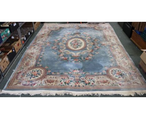 A large Chinese carved carpet, pale blue ground with pink rose decoration, deeply bordered &amp; fringed, 370cm x 276cm
