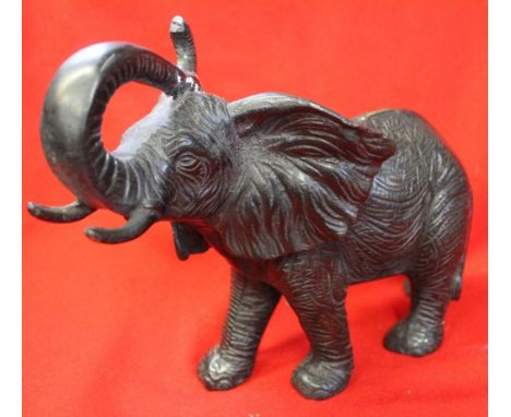 A cast metal bronzed elephant (considered to have been part of a lamp) 20cm high