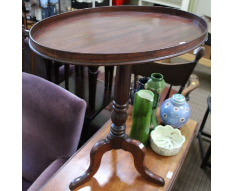 A 19th century mahogany occasional table, oval gallery top, on turned stem, with tripod supports, 64cm x 44cm