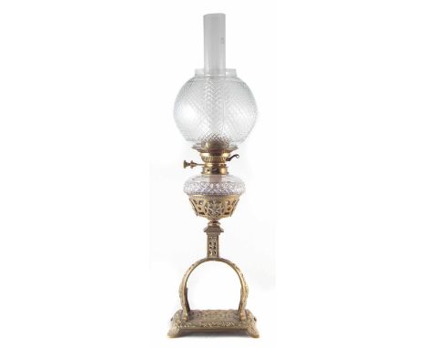 Rippingilles patent oil lamp, with pierced brass base, cut glass sit in reservoir and cut glass shade, late 19th century, 75c