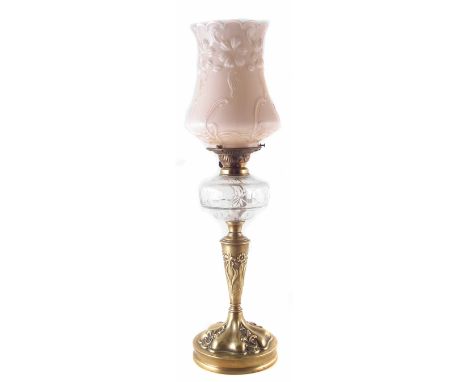 Victorian oil lamp, the brass base embossed with stylised flowers, fitted with pink glass shade, late 19th early 20th century