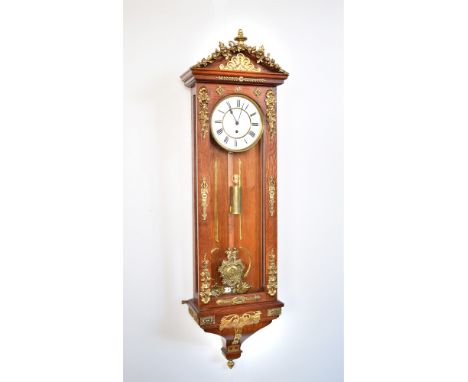 Vienna regulator with oak case. Mounted with gilt wreaths of wild-flowers and fruit. The pointed arched pediment has further 