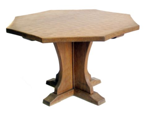 In the style of "Mouseman", octagonal pedestal dining table adzed top on support with four brackets, top diameter 124cm (49")