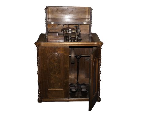 Sewing machine: a cabinet treadle sewing machine by Wheeler & Wilson, No. 216209, with gilt transfers  to the bedplate, plate
