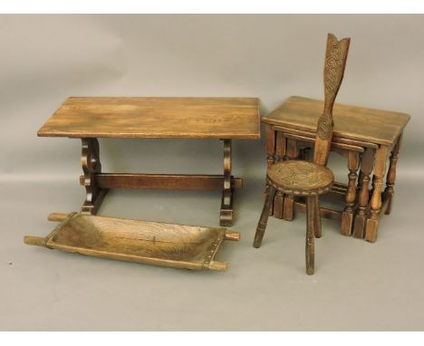 A nest of tables, a coffee table, a carved spinner's stool, and a wood trough