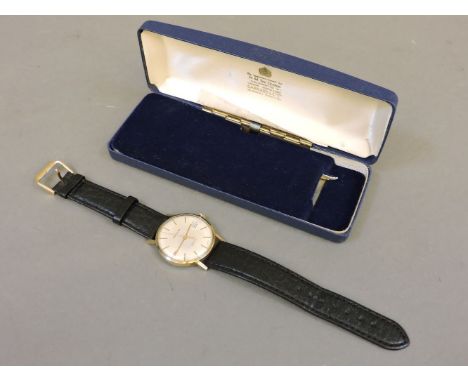 A gentleman's 9ct gold Garrard quartz strap watch, with engraved presentation message verso, original box