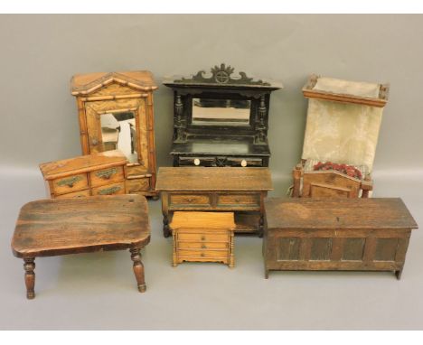 Seven miniature apprentice or doll's house furniture, a mirrored armoire, a half tester bed, a dresser, a coffer dresser, a c