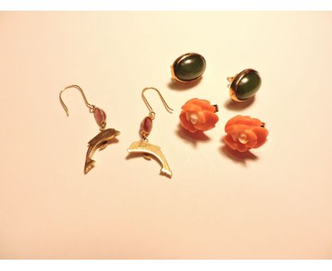 A pair of 9ct gold jade stud earrings, a pair of 9ct gold carved coral rosebud earrings, and a pair of cabochon ruby and dolp