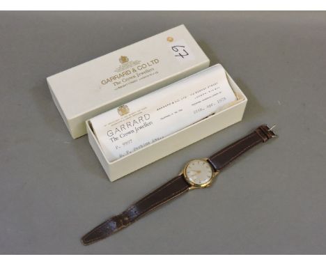 A gentleman's 9ct gold Garrard mechanical strap watch, with presentation message verso, box and a letter from Garrard