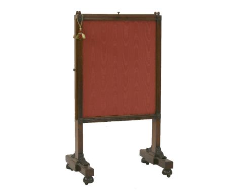 A mid 19th century mahogany firescreen, the moulded frame surmounted with acorn finials, with a rise/fall fabric panel and sl