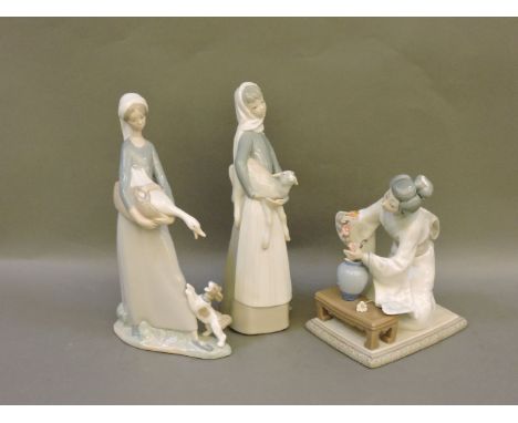 Three Lladro figures, Girl Holding Goose, Girl Holding Lamb, and Japanese Lady Tending Flowers, tallest 28cm