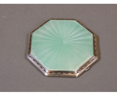 A sterling silver compact, with mint green guilloché enamel decoration to the front cover