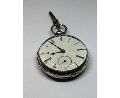 A HALLMARKED LONDON GEORGIAN SILVER POCKET WATCH WITH WHITE ENAMEL FACE, SUB DIAL AND ROMAN NUMERALS AND KEY