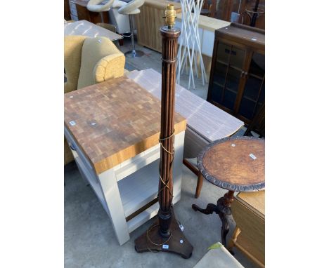 A MAHOGANY STANDARD LAMP WITH TURNED AND FLUTED COLUMN