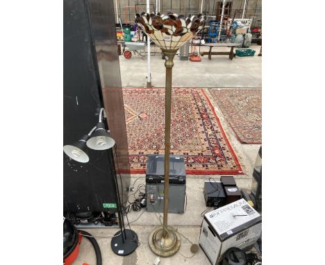 A METAL STANDARD LAMP WITH TIFFANY STYLE SHADE