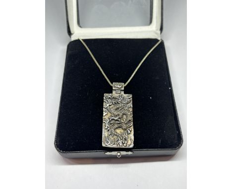 A SILVER CHINESE DRAGON NECKLACE IN A PRESENTATION BOX