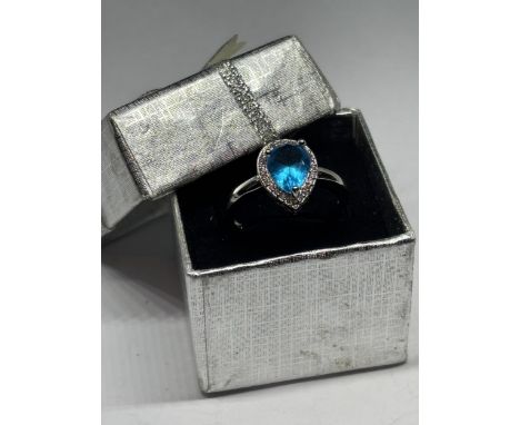 A MARKED 925 SILVER RING WITH A TEARDROP BLUE TOPAZ STONE IN A PRESENTATION BOX
