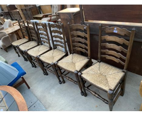 A SET OF SIX LANCASHIRE STYLE LADDER BACK DINING CHAIRS WITH RUSH SEATS