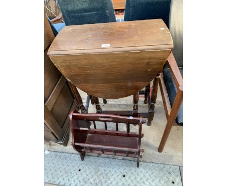A SMALL OVAL BEECH GATE LEG TABLE, 36" X 24" OPENED, ON TURNED LEGS AND MAGAZINE RACK