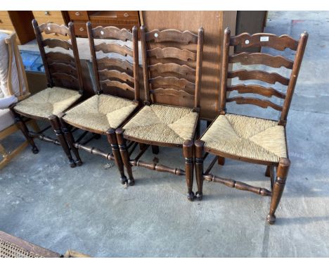 A SET OF FOUR LANCASHIRE STYLE LADDER BACK DINING CHAIRS WITH RUSH SEATS
