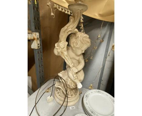 A LARGE CHERUB LAMP BASE WITH SILK LINED SHADE (A/F)
