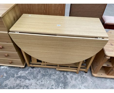 A GATE-LEG KITCHEN TABLE ENCLOSING FOUR FOLDING CHAIRS
