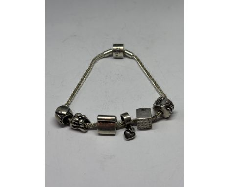 A RHONA SUTTON PANDORA STYLE SILVER BRACELET WITH SIX CHARMS