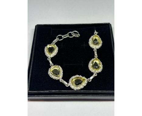 A MARKED 925 SILVER BRACELET WITH LIME GREEN STONES