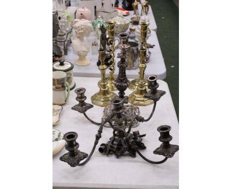A PAIR OF TALL BRASS BARLEY TWIST CANDLESTICKS TOGETHER WITH A FURTHER PAIR,  A LARGE SILVERPLATE CARVED REPOUSSE CANDLESTICK