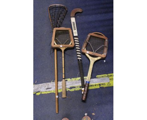 A QUANTITY OF VINTAGE SPORTS EQUIPMENT TO INCLUDE A SLAZENGER HOCKEY STICK, DUNLOP TENNIS RACKET IN WOODEN FRAME, ETC.,